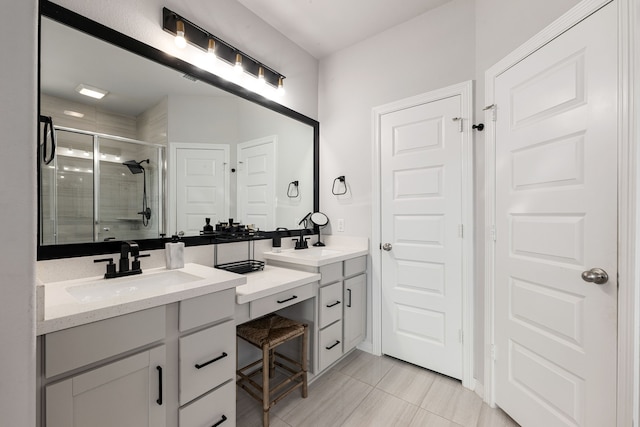 full bath with tile patterned floors, vanity, and a shower stall