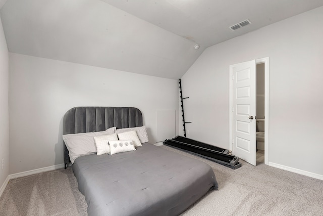 carpeted bedroom featuring lofted ceiling, visible vents, and baseboards