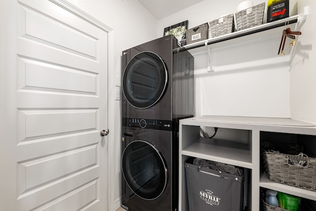 washroom with stacked washer / drying machine and laundry area