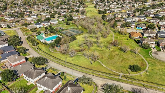aerial overview of property's location with nearby suburban area and a pool area