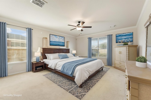 bedroom with light carpet, crown molding, baseboards, and ceiling fan