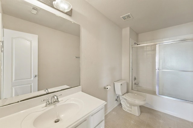 full bathroom featuring tile patterned floors, toilet, vanity, baseboards, and bath / shower combo with glass door