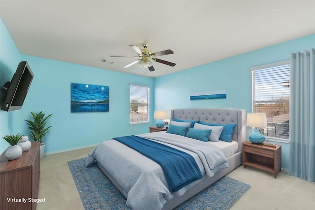 bedroom with light carpet, baseboards, and ceiling fan