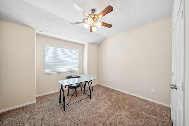 carpeted office space featuring baseboards, ceiling fan, a textured ceiling, and lofted ceiling