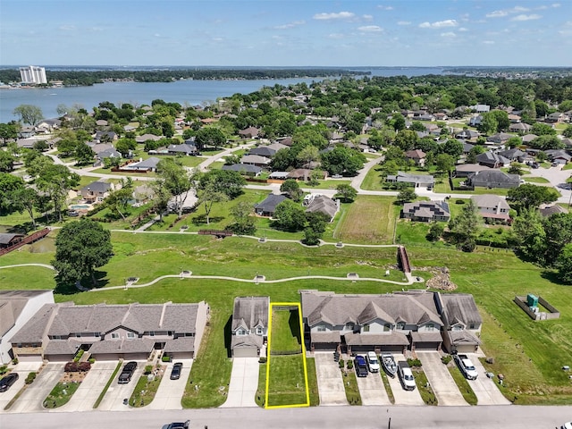 drone / aerial view featuring a water view and a residential view