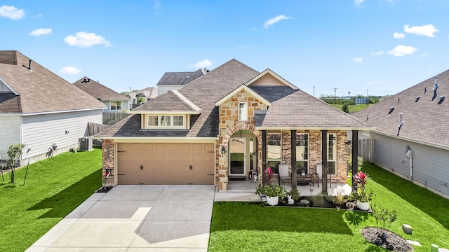 craftsman-style home with a front lawn, central AC unit, driveway, stone siding, and brick siding