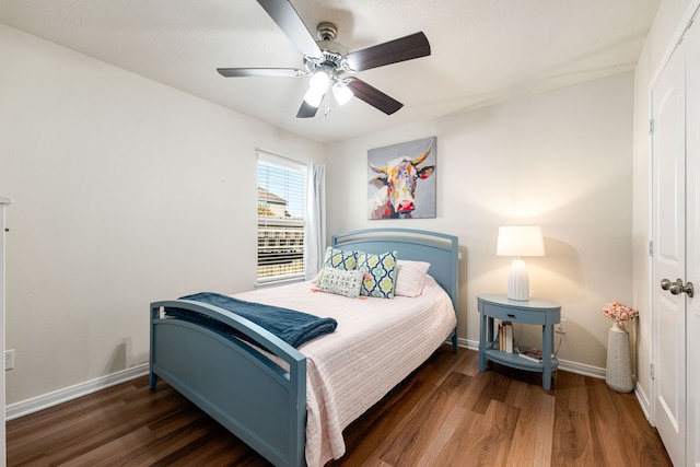bedroom featuring wood finished floors, baseboards, and ceiling fan