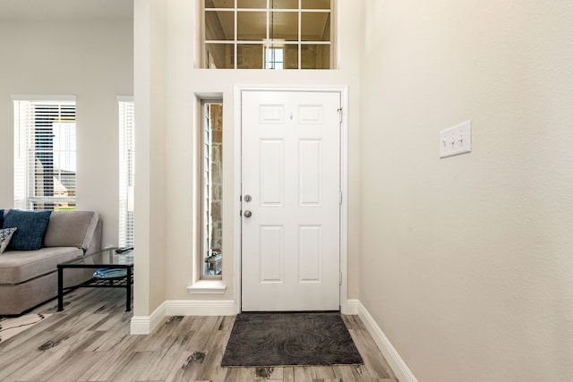 entrance foyer featuring light wood finished floors and baseboards