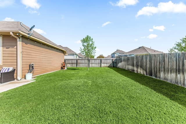view of yard with a fenced backyard