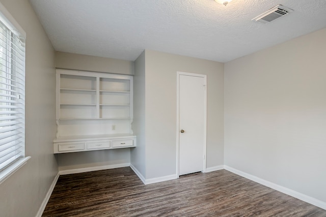 10610 Dunbrook Dr, Houston, TX 77070 - spare room with dark wood-type flooring, a textured ceiling, visible vents, and baseboards