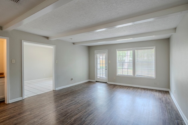 10610 Dunbrook Dr, Houston, TX 77070 - unfurnished room featuring baseboards, wood finished floors, beam ceiling, and a textured ceiling