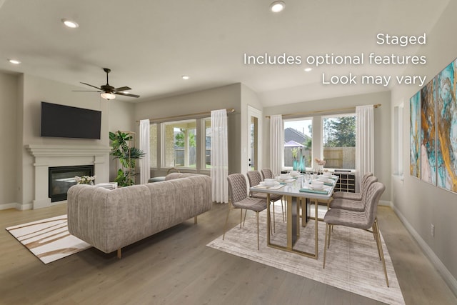 13136 Soaring Forest Dr, Conroe, TX 77302 - living area featuring plenty of natural light, wood finished floors, recessed lighting, baseboards, and a glass covered fireplace