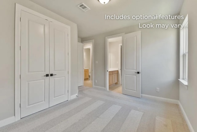 13136 Soaring Forest Dr, Conroe, TX 77302 - unfurnished bedroom with baseboards, light colored carpet, ensuite bathroom, and a closet