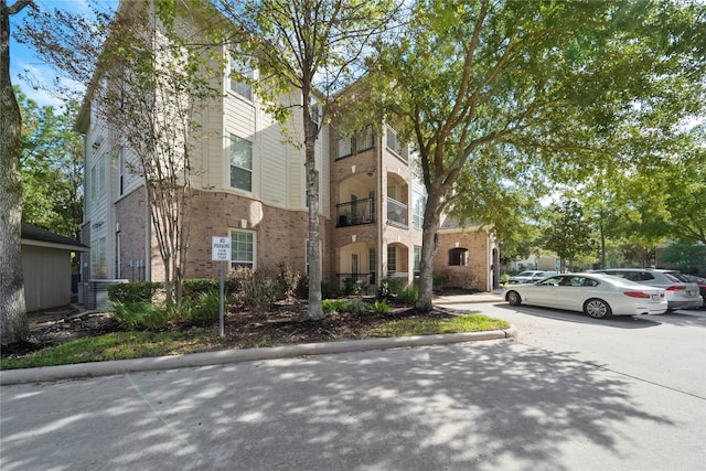 view of front of house with brick siding and central AC