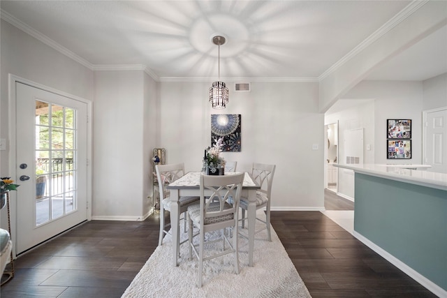 dining space featuring baseboards, ornamental molding, dark wood-type flooring, and visible vents