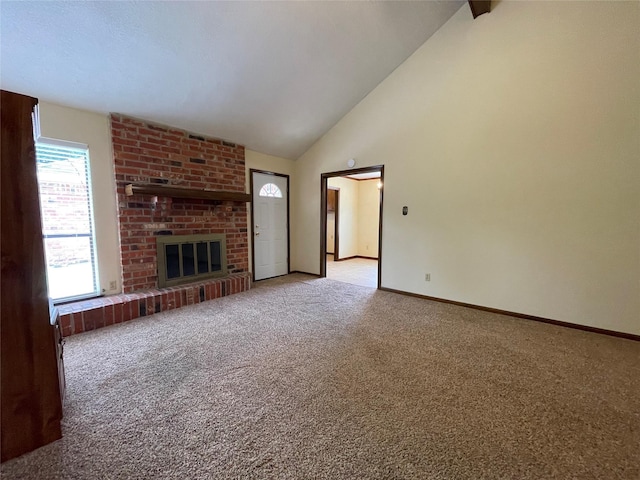 unfurnished living room featuring light colored carpet, high vaulted ceiling, baseboards, and a fireplace