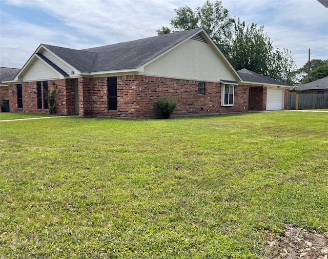 view of home's exterior featuring an attached garage, brick siding, and a yard