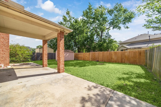 view of yard with a patio area, a fenced backyard, an outdoor structure, and a shed