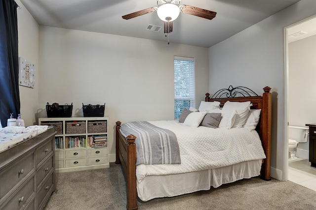 carpeted bedroom with ensuite bath, a ceiling fan, and visible vents