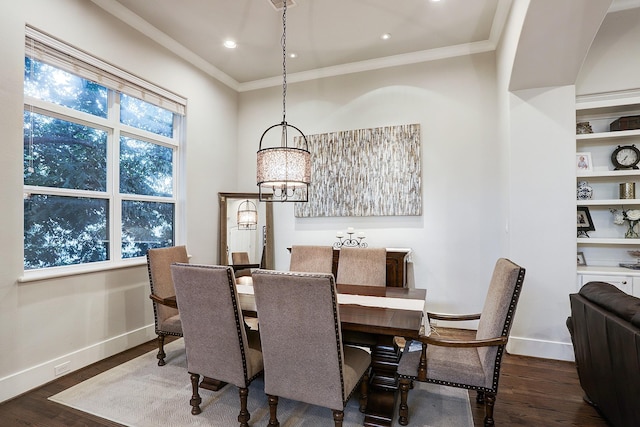 dining room featuring wood finished floors, ornamental molding, recessed lighting, a chandelier, and baseboards