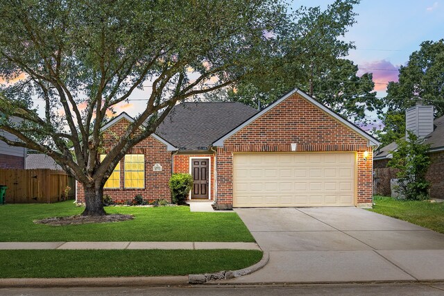 6723 Cypress Glades Dr, Katy, TX 77449 - traditional home featuring a garage, driveway, fence, a front yard, and brick siding