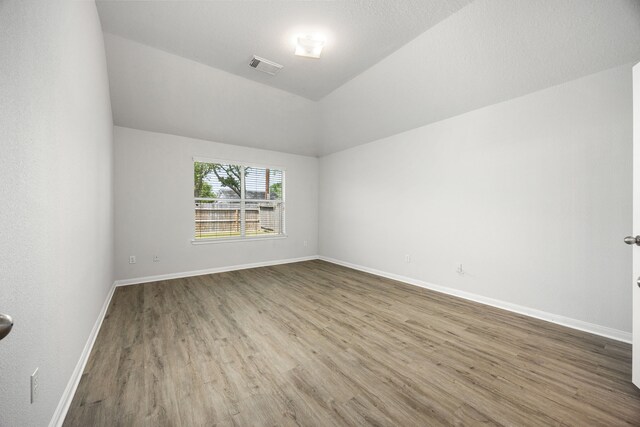 6723 Cypress Glades Dr, Katy, TX 77449 - unfurnished room with wood finished floors, visible vents, lofted ceiling, and baseboards