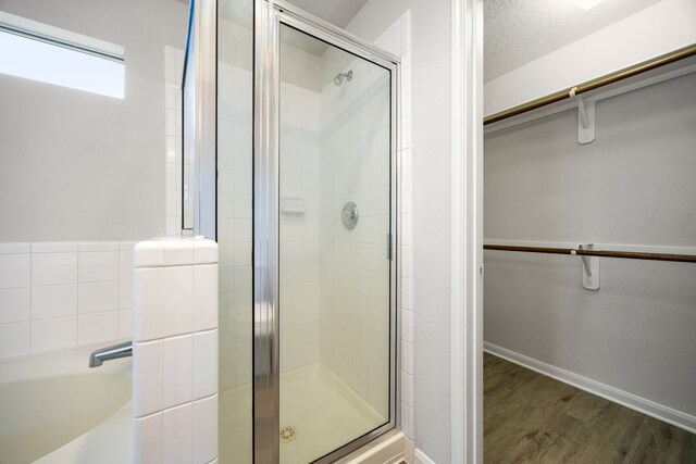 6723 Cypress Glades Dr, Katy, TX 77449 - bathroom with a shower stall, baseboards, a walk in closet, and wood finished floors