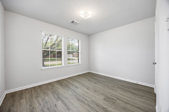 6723 Cypress Glades Dr, Katy, TX 77449 - unfurnished room featuring baseboards, wood finished floors, and visible vents