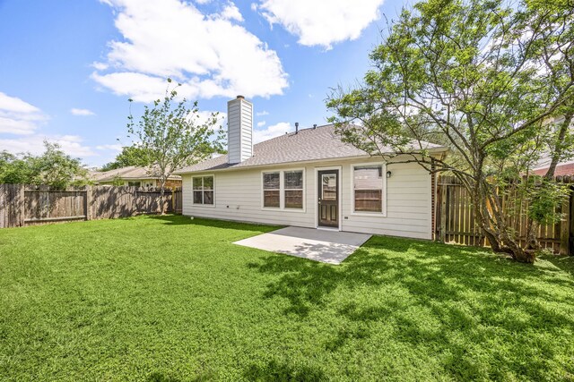 6723 Cypress Glades Dr, Katy, TX 77449 - rear view of property with a fenced backyard, a chimney, a shingled roof, a yard, and a patio