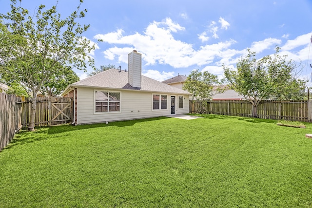 6723 Cypress Glades Dr, Katy, TX 77449 - rear view of house with a patio area, a chimney, a lawn, a fenced backyard, and roof with shingles