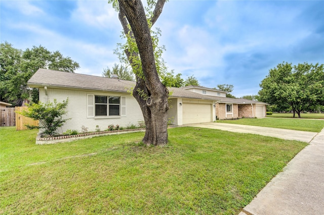 single story home featuring driveway, an attached garage, fence, a front yard, and brick siding