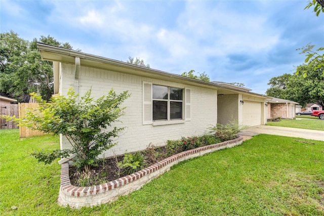 ranch-style home featuring driveway, fence, a garage, brick siding, and a front yard