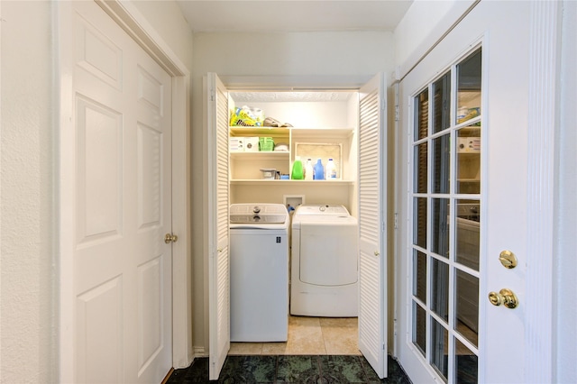 laundry area featuring washing machine and dryer and tile patterned flooring