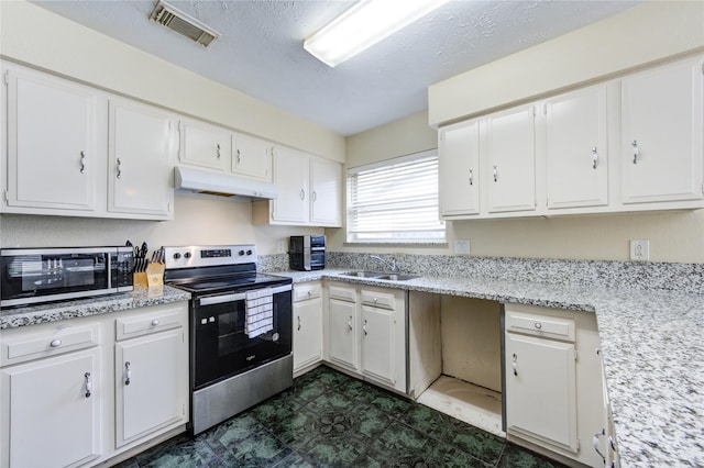 kitchen featuring white cabinets, under cabinet range hood, stainless steel appliances, visible vents, and a sink