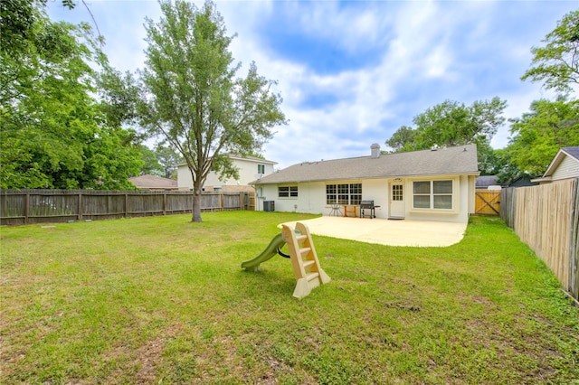rear view of house with a lawn, a fenced backyard, a patio, and central AC