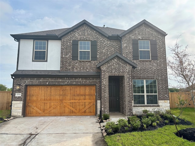 2014 Sunflower Ct, Sugar Land, TX 77498 - view of front of home featuring fence, a garage, driveway, brick siding, and roof with shingles