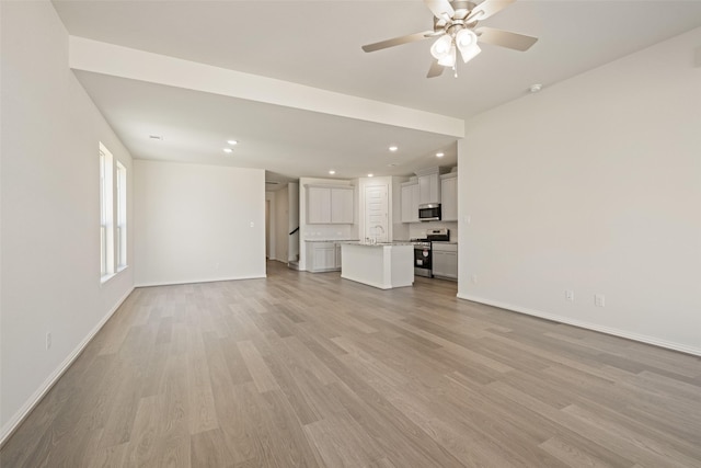 2014 Sunflower Ct, Sugar Land, TX 77498 - unfurnished living room featuring baseboards, light wood-style floors, recessed lighting, and ceiling fan