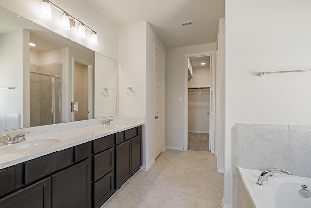 2014 Sunflower Ct, Sugar Land, TX 77498 - bathroom with a stall shower, a walk in closet, a garden tub, double vanity, and tile patterned flooring