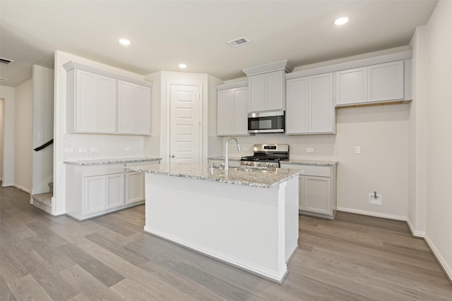 2014 Sunflower Ct, Sugar Land, TX 77498 - kitchen with stainless steel appliances, backsplash, light wood-style flooring, a sink, and recessed lighting