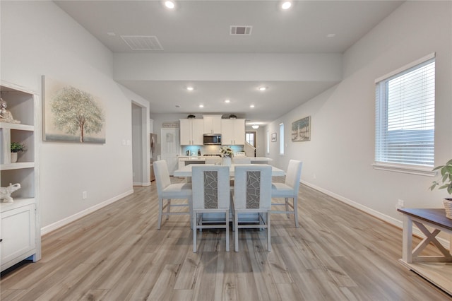 dining room with visible vents, recessed lighting, and light wood-style floors