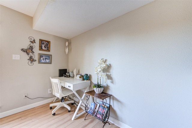 office space with baseboards and wood finished floors