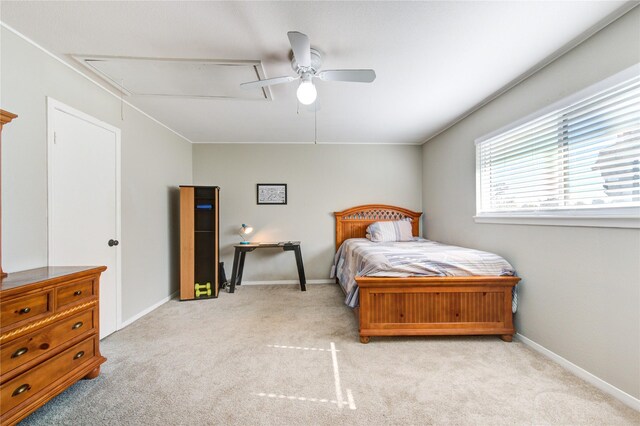 bedroom with attic access, a ceiling fan, baseboards, and carpet