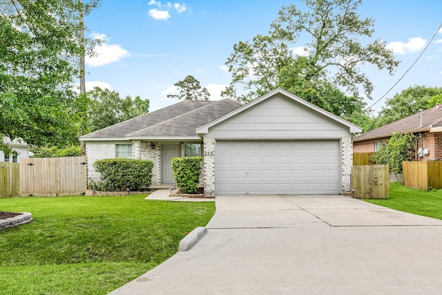 ranch-style house with fence, an attached garage, a front lawn, and brick siding