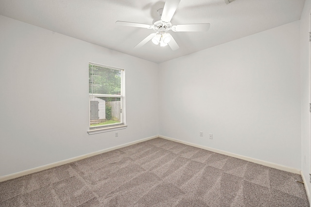 spare room featuring baseboards, ceiling fan, and light colored carpet