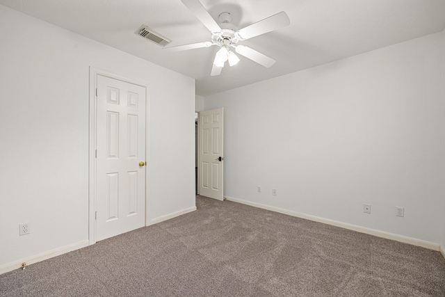 unfurnished bedroom featuring visible vents, carpet flooring, baseboards, and a ceiling fan