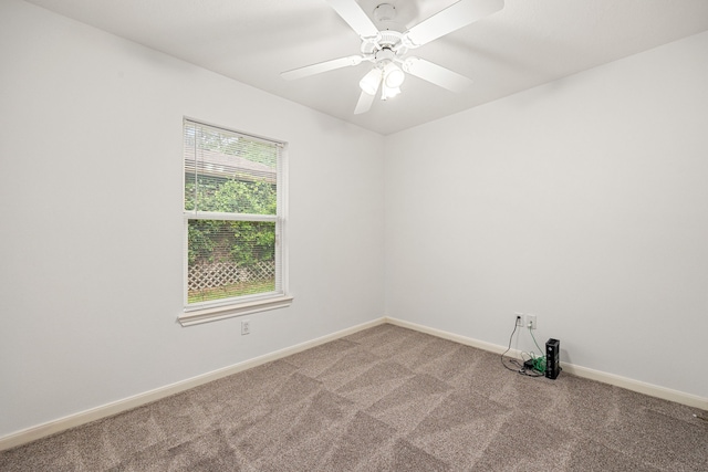 carpeted spare room with baseboards and ceiling fan