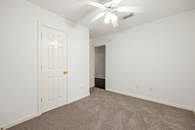 unfurnished bedroom featuring visible vents, carpet flooring, baseboards, and ceiling fan
