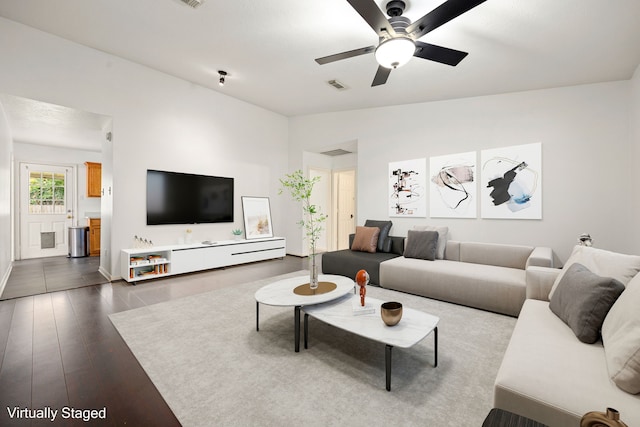living area with ceiling fan, visible vents, and wood finished floors
