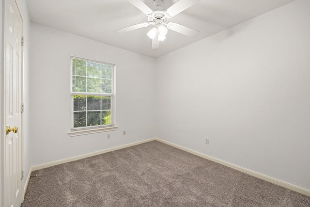 carpeted empty room with baseboards and a ceiling fan