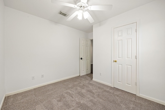 unfurnished bedroom featuring carpet floors, baseboards, ceiling fan, and visible vents